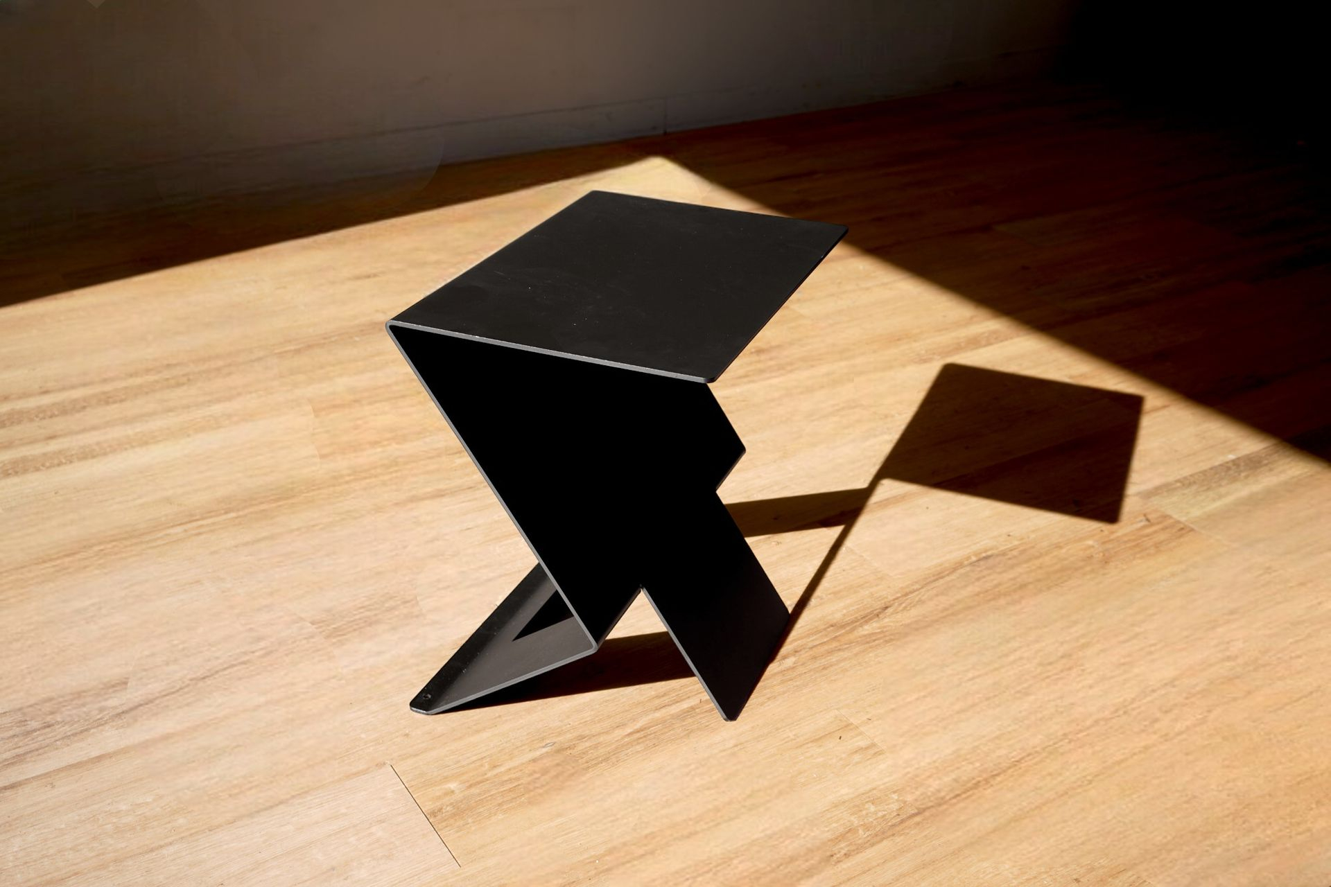 theZign side table showing its original folded-metal top and angular support